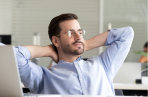 Relaxed confident business man taking break from work on laptop