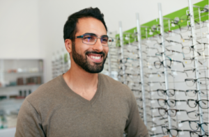 Man Trying On Eyeglasses In Optics Store