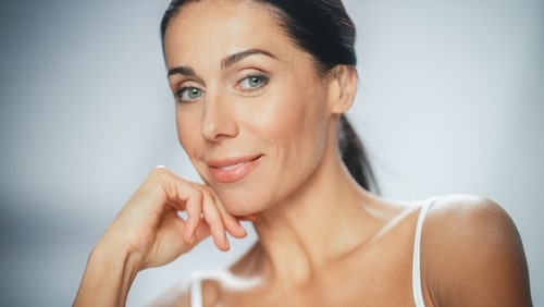 Beautiful Caucasian Woman Touches Her Perfect Face Smiling