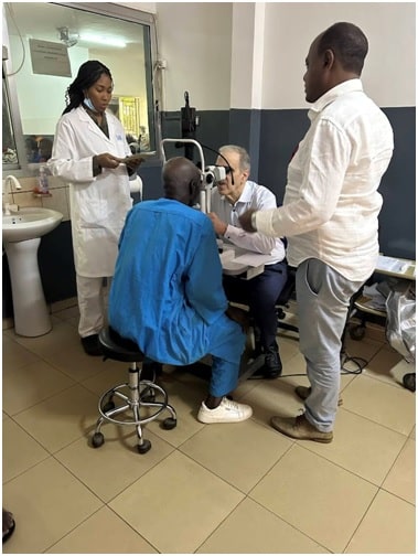 Dr. Stuart Sondheimer and Dr. Amde Michael Ketema examining patient after cataract surgery in Guinea. (Bonnie Sondheimer/Provided by Dr. Stuart Sondheimer)